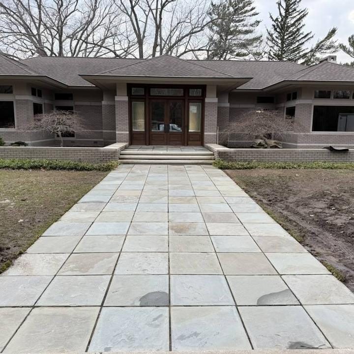 A clean paver walkway leading to a front door.