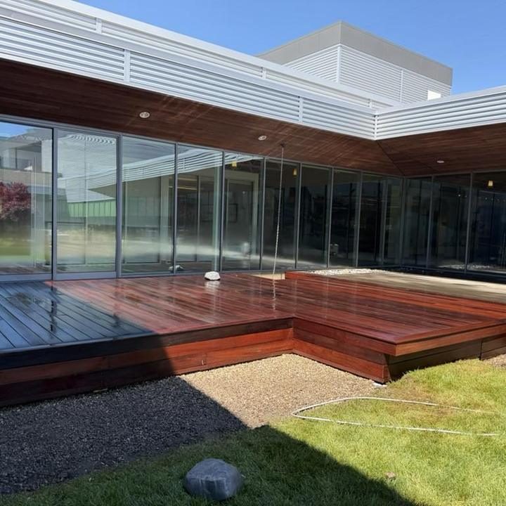 A restored hardwood boardwalk beside a commercial building.