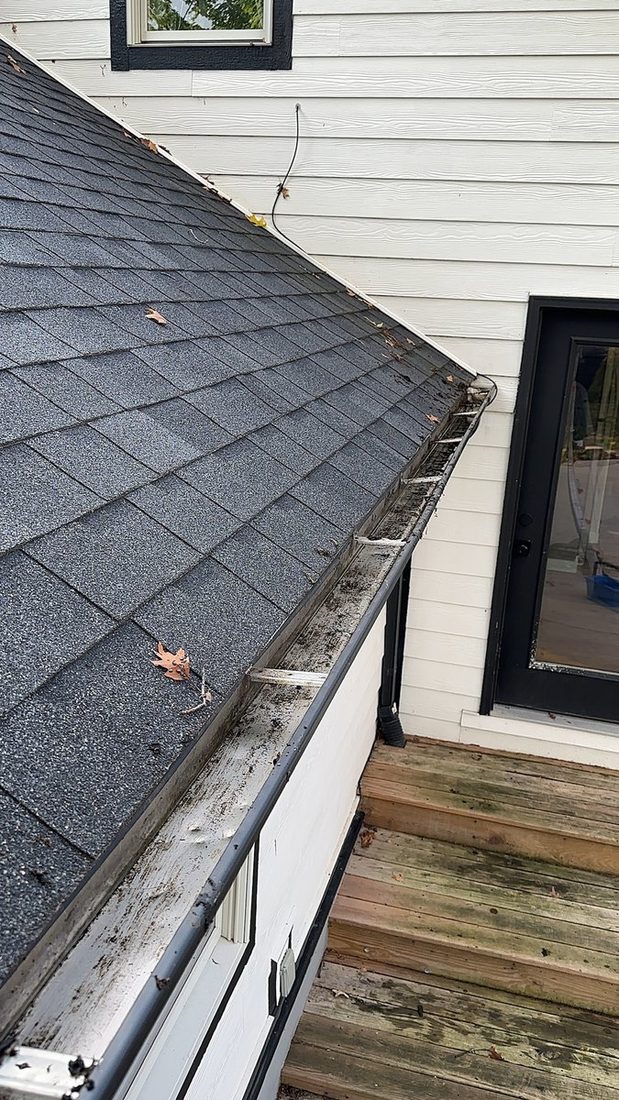 The same gutter run cleared back to bare metal.