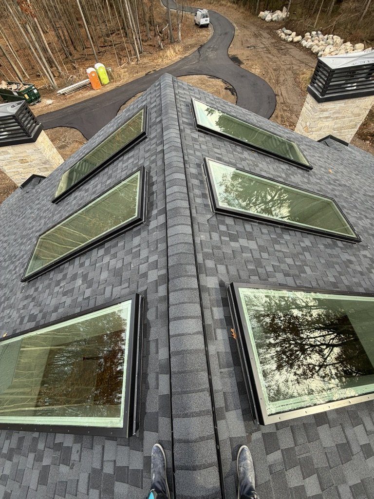 Skylights cleaned on a new-build roof, the site still unfinished below.