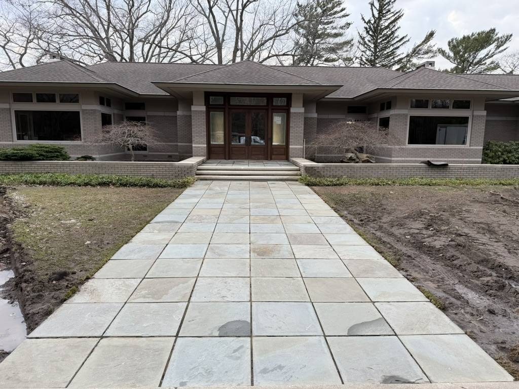 A paver walkway leading to a front door after cleaning.
